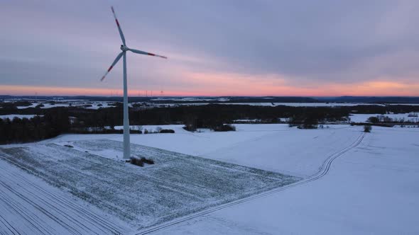 Aerial view of a wind farm in winter. Aerial view of rotating wind turbines.