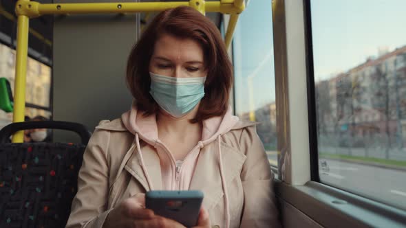 Woman traveling in bus and using phone alt