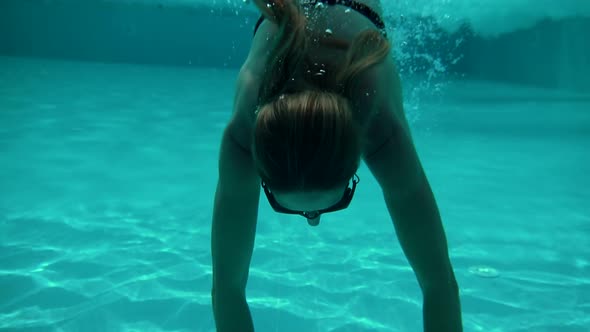 Carefree Girl Relaxing Dive And Enjoying In Hot Day. Lady Relaxing Leisure In Swimming Pool Hotel. alt