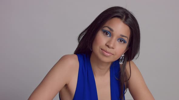 Mixed Race Young Woman Withbright Blue Makeup in Studio Shoot in Electric Blue Dress