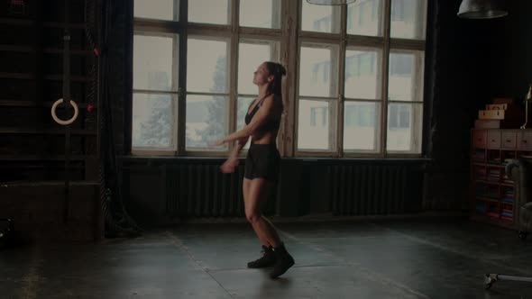 Athletic Fit Female Doing Warmup During Intensive Workout in Gym alt