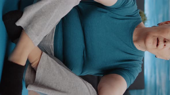 Vertical Video Aged Woman Doing Meditation Sitting in Lotus Position alt