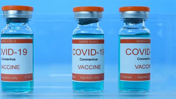 Scientist's Hand Folds Ampoules With Covid-19 Vaccine.
