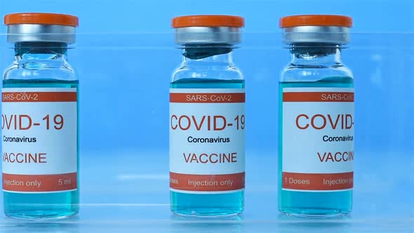 Scientist's Hand Folds Ampoules With Covid-19 Vaccine. alt