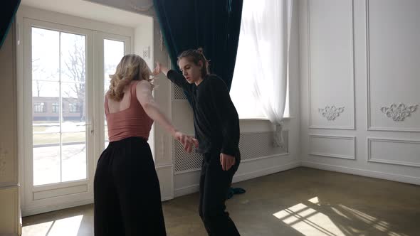 a Young Couple is Dancing in a Spacious Bright Room alt