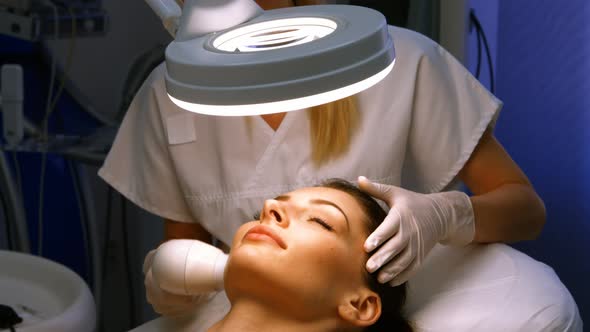 Doctor giving facial massage through soniclifting alt