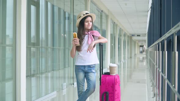 Little Girl Eat Fast Food and at the Airport While Waiting for the Plane alt