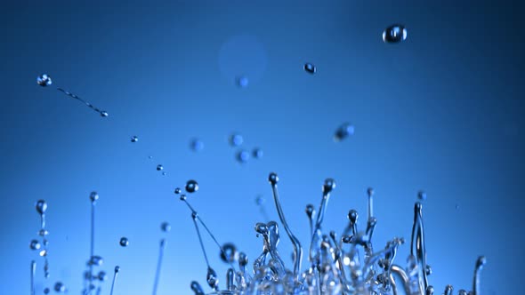 Super Slow Motion Shot of Splashing Blue Liquid on Gradient Background at 1000Fps alt