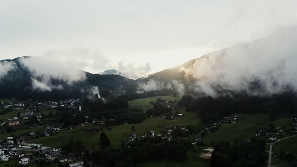Panoramic View of a Picturesque Mountain Valley with a Village in a Lowland alt