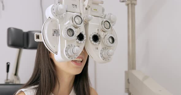 young woman having eye test alt