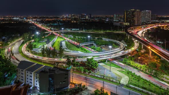 Highway interchange junction and traffic during rush hour in Bangkok, at night - time lapse