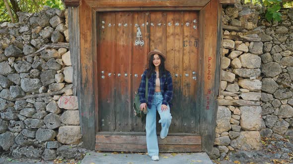 Tourist Woman in Front of Old Door alt