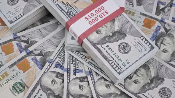 Dollars Bundles Rotate on a Heap of Money Stacks of 10000 American Banknotes alt