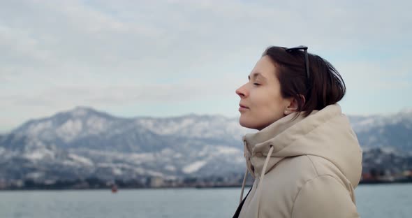 Side Portrait of Young Woman Looking Up at Sky Copy Text Space Handheld Device alt