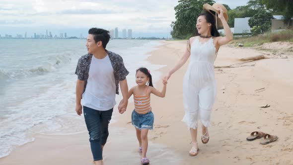Asian Family walking at beach with kids happy vacation concept