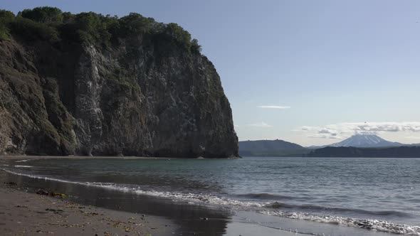 Calm Waves on Sea, Beach from Black Sand, Rocky Shores Pacific Ocean. Time Lapse