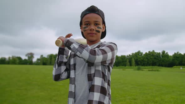 Little Baseball Player Batting Waiting for Pitch on Green Field alt