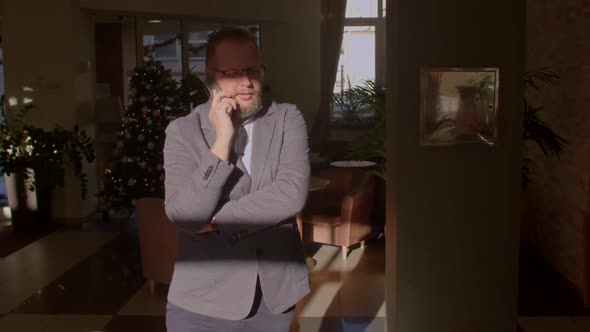 Businessman While Talking on Phone alt