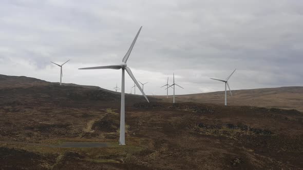 Wind farm in Scotland with turbines for electrical energy generation alt