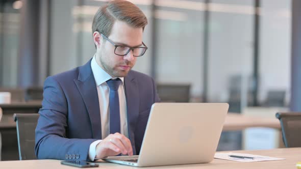 Businessman with Laptop having Loss, Failure alt