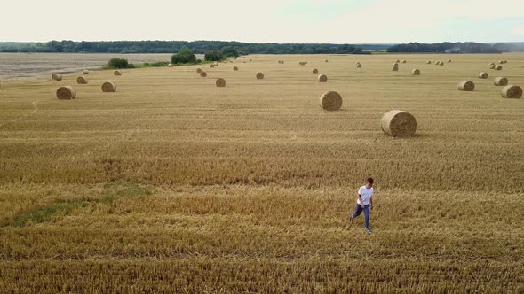 Little Boy In Field. Beautiful boy walking in a field with straw alt