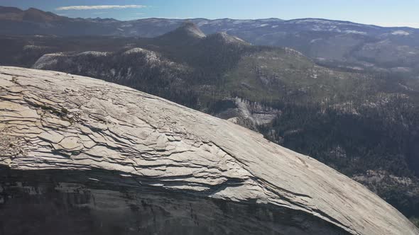 Aerial Footage of the Top of Half Dome Mountain Against the Background of Sierra Nevada Range alt