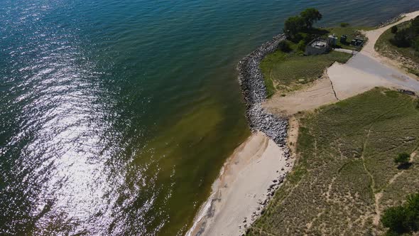 Lush trees and sunlight reflecting off of multiple lakes close to Lake Michigan. alt