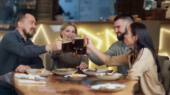 Four Friends Toasting Mug Malt Relaxing in Pub Sitting at Table alt