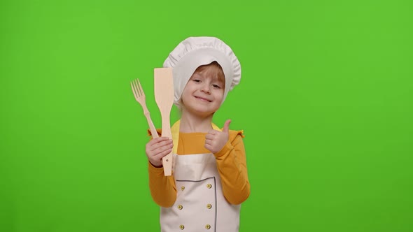 Child Girl Cook Chef Baker in Apron and Hat Smiling Nods Head in Agreement on Chroma Key Background alt