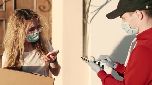 Customer Pretty Woman Paying for Lunch Box Using NFC Technology with Phone and Credit Card alt