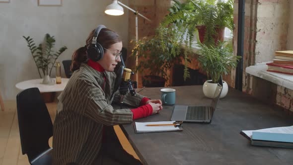 Female Podcaster Working in Recording Studio alt