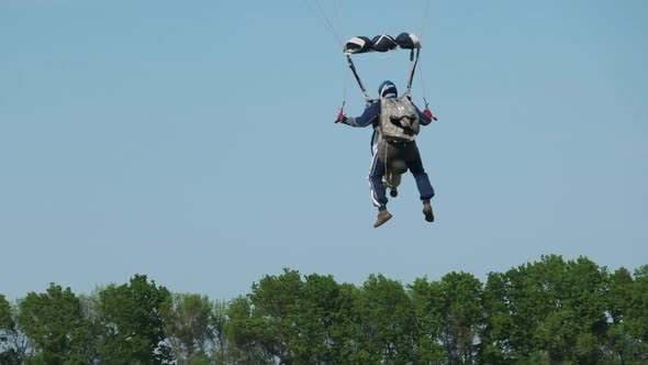 Parachutists in Tandem Flying in the Sky and Landing on Field Slow Motion alt