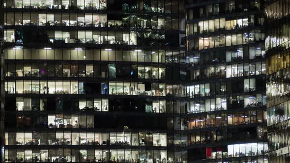 View of office windows with working people alt