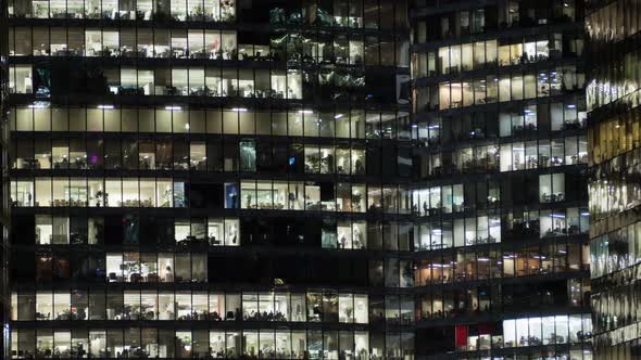 View of office windows with working people