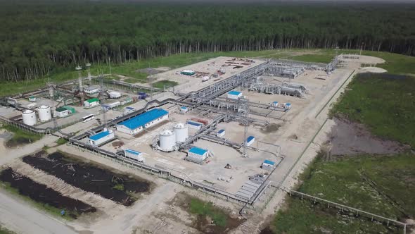Oil refinery areas of the oil corporation among dense coniferous forests taken from the air alt