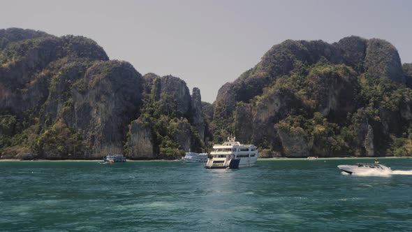 Sailing and Motor Boats Moving Near the Koh Phi Phi Island Pier in Thailand. LIfestyle Travel Video