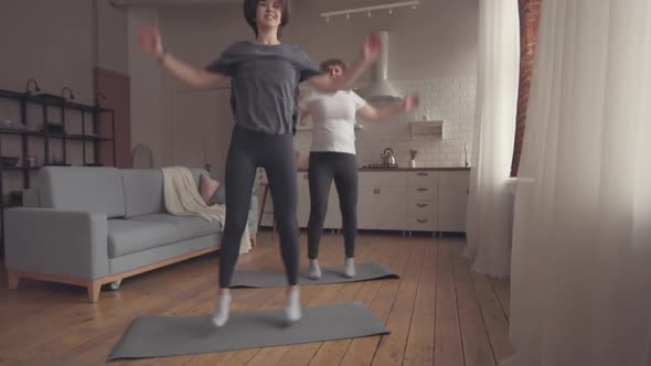 Mom and Daughter Doing the Home Fitness Exercises.