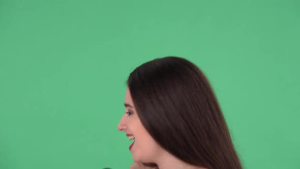 Portrait of Beautiful Young Woman Sings Song Into Microphone and Dances to Music alt