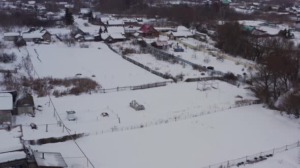 Old Wooden Houses in the Russian Village Covered with Snow