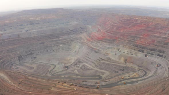 Aerial View of Opencast Mining Quarry with Lots of Machinery at Work alt