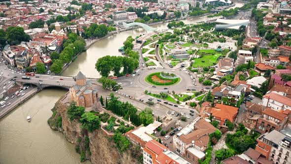 Aerial drone view of Tbilisi, Georgia at cloudy weather. Metekhi Church, Rike Park, water channel, m alt