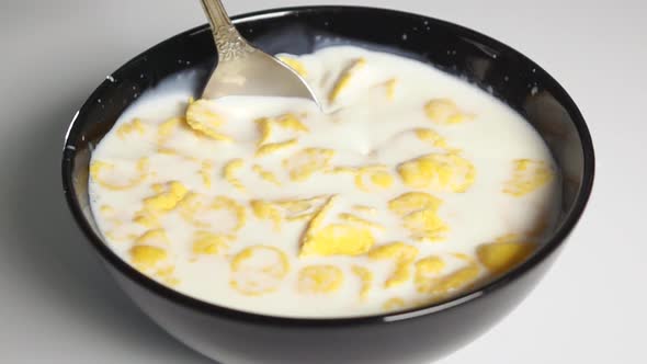Mix Cornflakes in Milk By Spoon alt