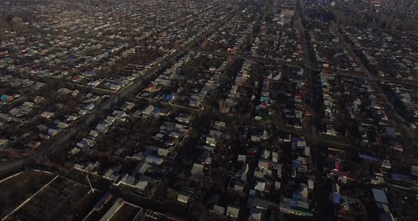Tilt up Drone camera movement on top of Karakol city by a sunny morning. alt