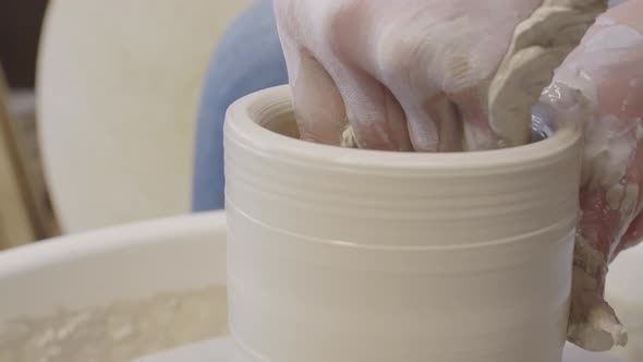 Skillful Artisan Making Argil Pot on Potter Wheel alt