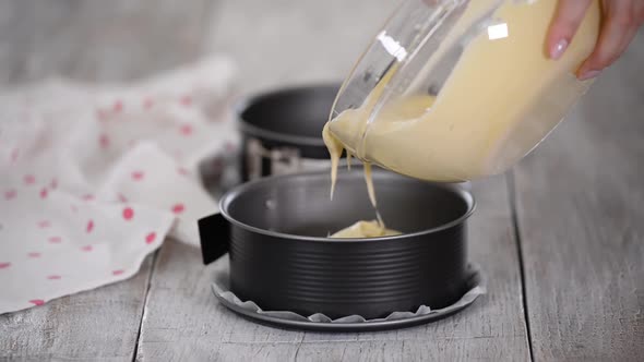 Woman Pouring Cake Batter Into Cake Mold
