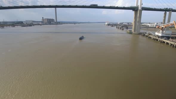 Small Boat Travelling Under Bridge alt