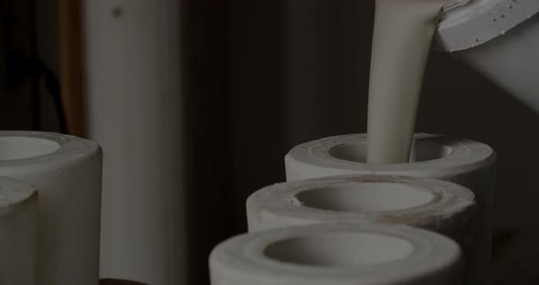 Pouring Clay Into Forms At Pottery Studio alt