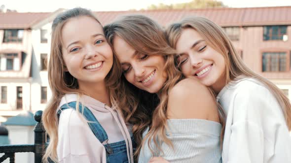 Three young female hipster friends. Girls dressed in summer casual clothes alt
