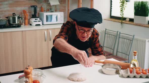 Sieving Flour on a Wooden Chopping Board to Make Dough alt