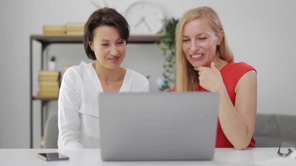 Excited Women Using Laptop